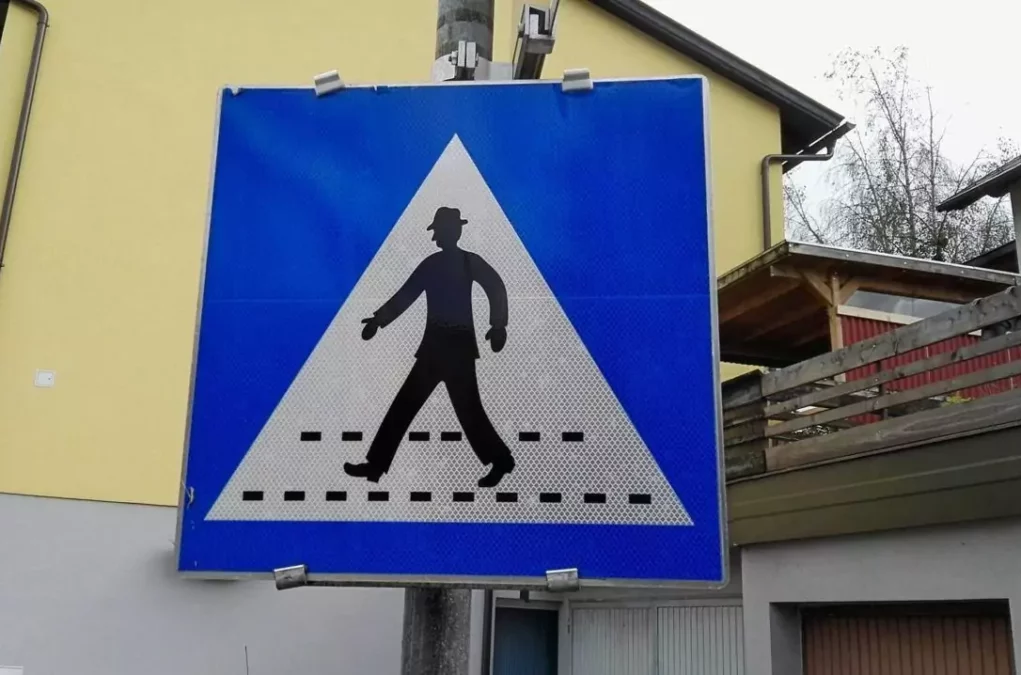 Foto zu einem Beitrag von 5min.at: Schild weist auf einen Fußgänger-Zebrastreifen hin.