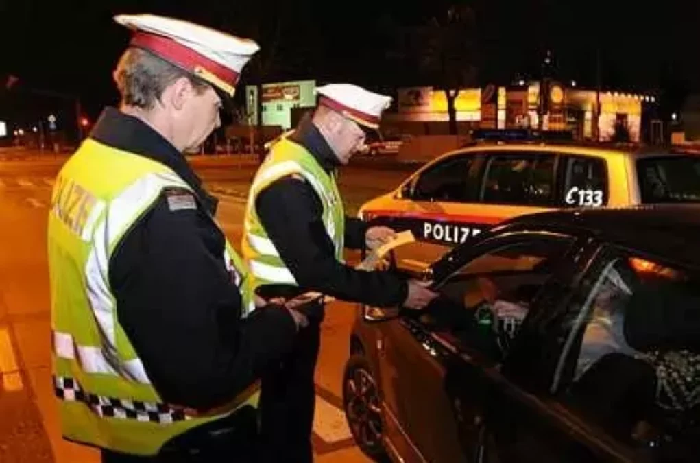 Symbolfoto von 5min.at: Polizisten bei einer Verkehrskontrolle in der Nacht.