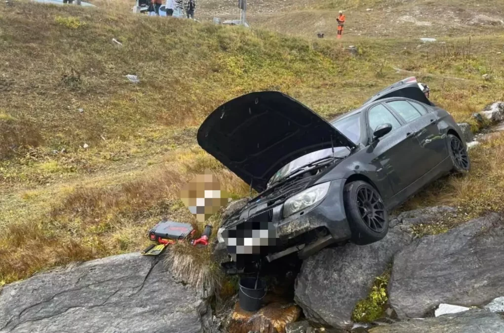 Foto in Beitrag von 5min.at: Unfallauto zu sehen, wie es zerstört im Hang hängt.