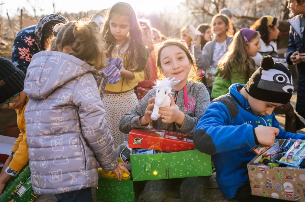 Bild auf 5min.at zeigt mehrere Kinder mit Weihnachtsgeschenken in der Hand.