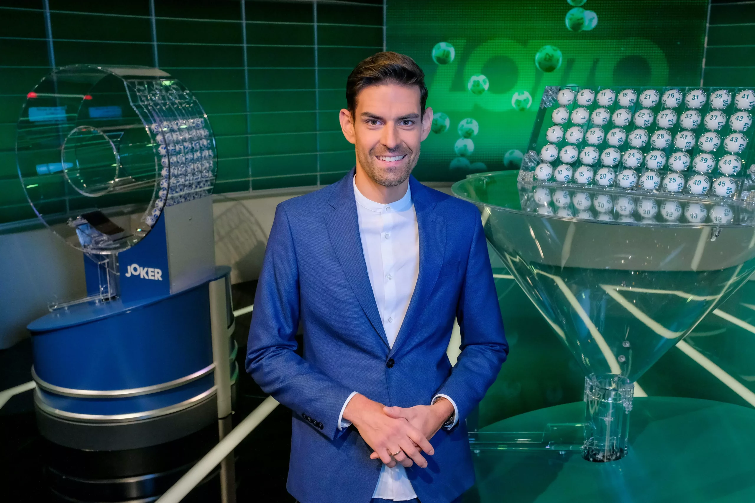 Ein Bild auf 5min.at zeigt den Moderator Ralph Huber-Blechinger bei der Lottoziehung.