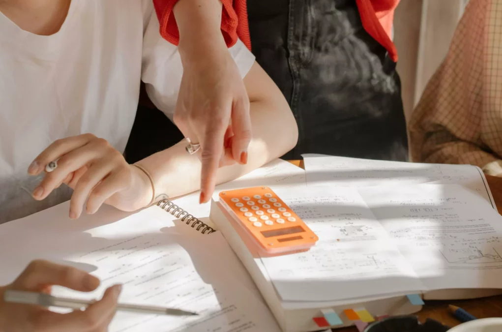 Das Bild auf 5min.at zeigt mehrere Personen, die mit Rechnungen beschäftigt sind.