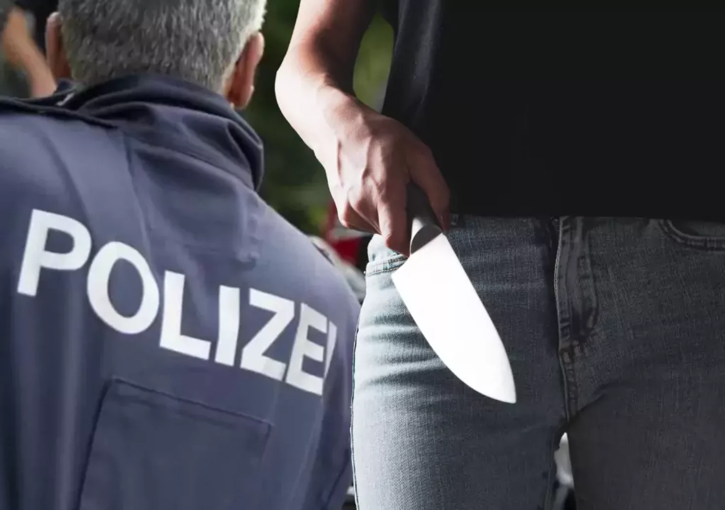 Bild auf 5min.at zeigt ein Polizist und eine Frau mit einem Messer in der Hand.