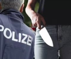 Bild auf 5min.at zeigt ein Polizist und eine Frau mit einem Messer in der Hand.