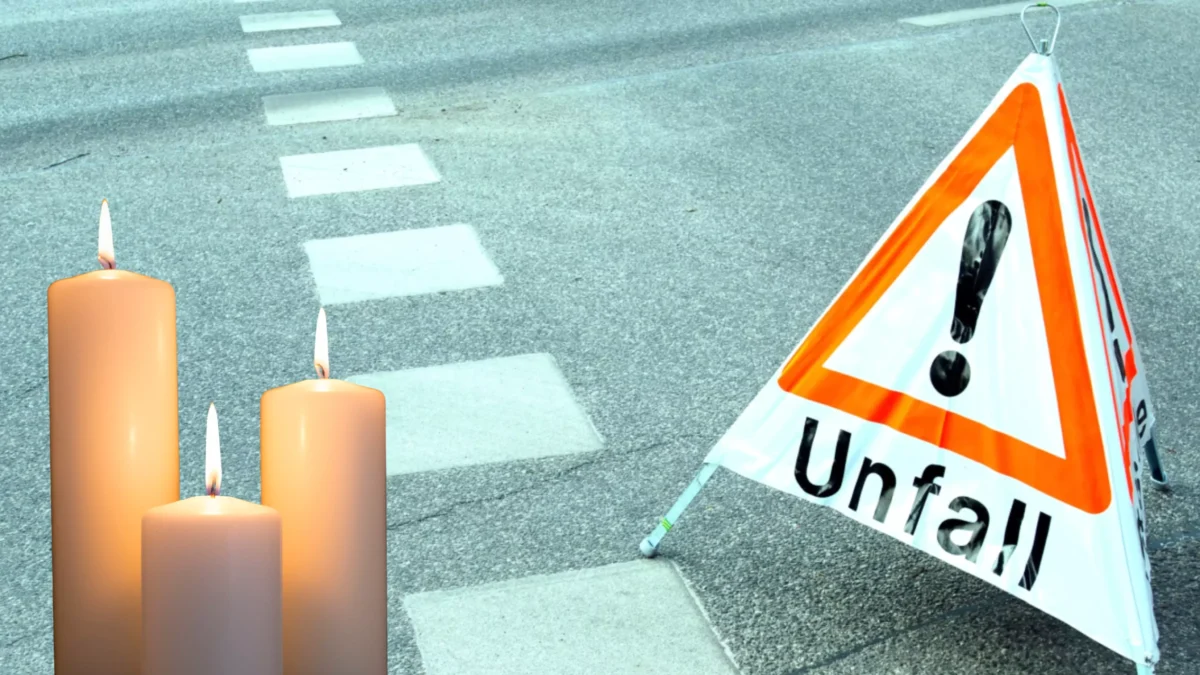 Das Bild auf 5min.at zeigt ein Unfallschild auf der Straße und Kerzen.