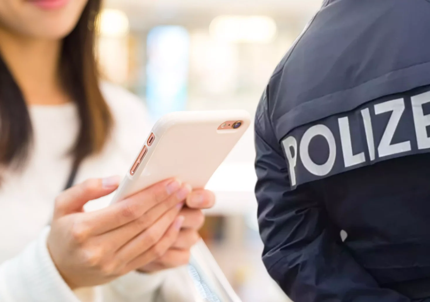Eine Bildmontage auf 5min.at zeigt eine Frau, die auf ein Smartphone schaut sowie einen Polizeibeamten.
