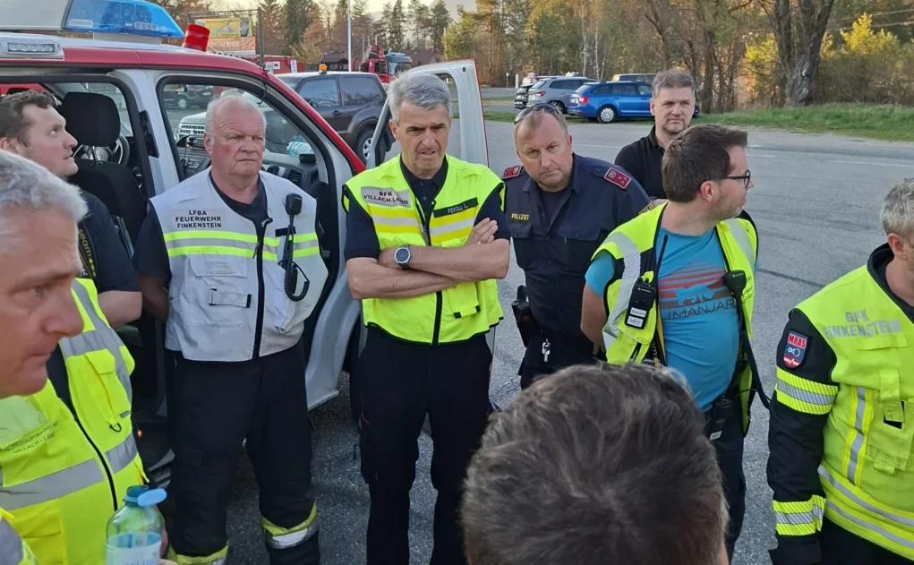 Ein Bild auf 5min.at zeigt Feuerwehrleute, die beieinander stehen.
