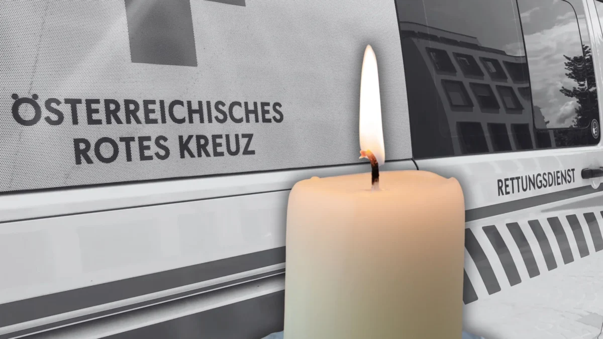 Foto in Beitrag von 5min.at zeigt eine Kerze und dahinter ein Rettungsauto in schwarz-weiß.