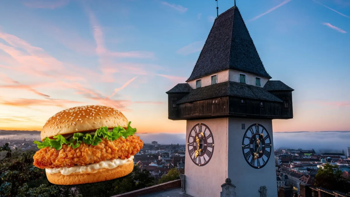 Auf dem Foto von www.5min.at sieht man einen Burger und den Grazer Uhrturm.